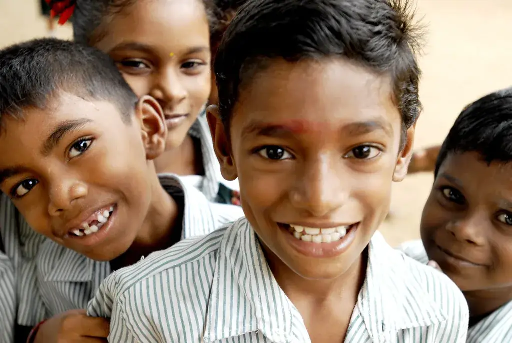 Schoolchildren in uniform smiling at the camera
