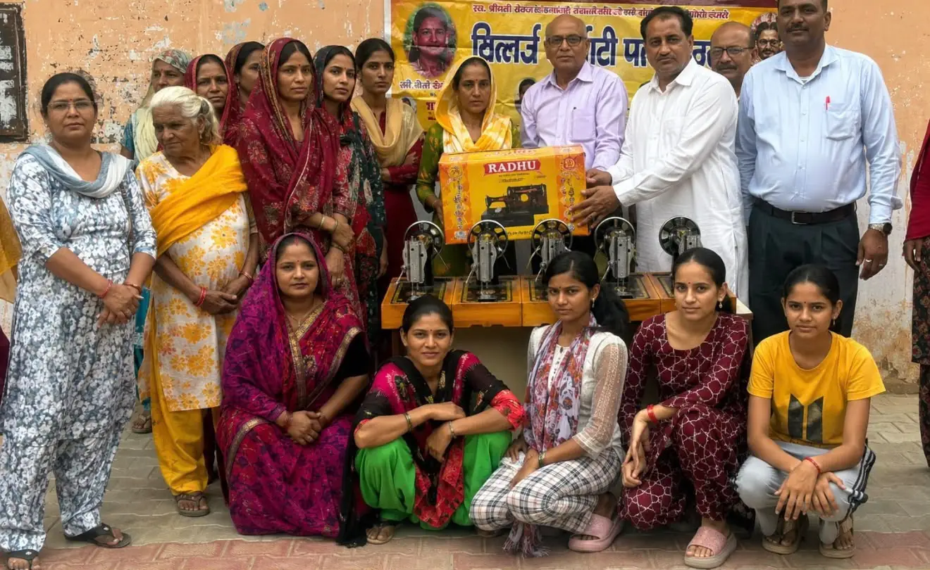 Women gathered around a row of new sewing machines at a sewing and beauty parlour centre